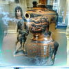 A great smoking urn from which the images of strange warriors from despotic eras arise.png