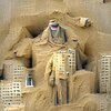 A man made of buildings covered in sand.jpg